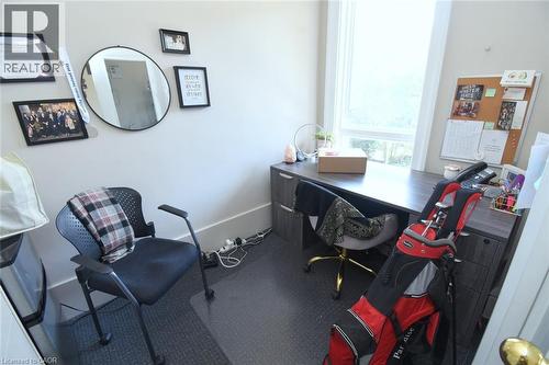 Bright room featuring a large window, light-toned walls, and dark-toned flooring - 108 George Street, Hamilton, ON 