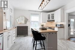 Sparkling white kitchen with new vinyl plank floor - 