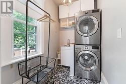 Main floor laundry room, sink & storage cupboards - 