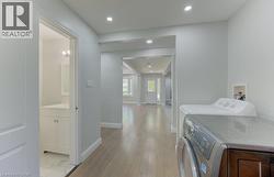 Dedicated laundry area with a front-loading washer and top-loading dryer - 