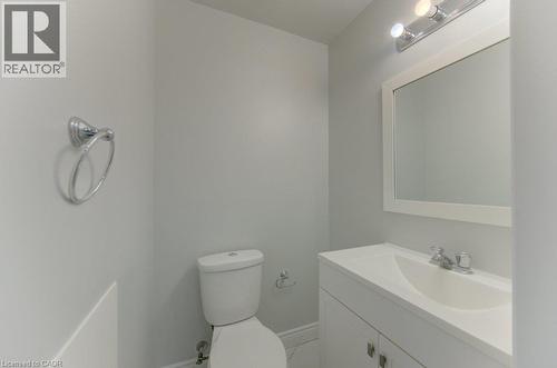 Contemporary bathroom featuring a white vanity with integrated sink, framed mirror, and chrome fixtures - 80 Lower Canada Crescent, Kitchener, ON - Indoor Photo Showing Bathroom