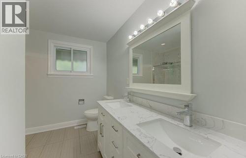 Bathroom featuring a double vanity with stone-finish countertops, undermount sinks, and chrome faucets - 80 Lower Canada Crescent, Kitchener, ON - Indoor Photo Showing Bathroom