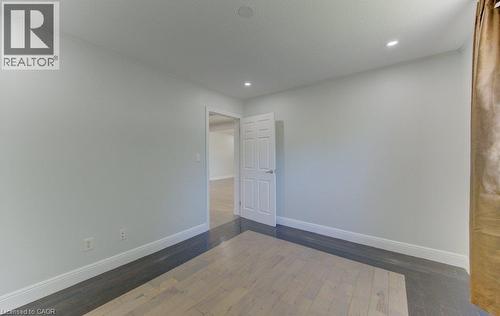 Room featuring light-toned flooring, recessed ceiling lighting, white baseboards, and a paneled door - 80 Lower Canada Crescent, Kitchener, ON - Indoor Photo Showing Other Room