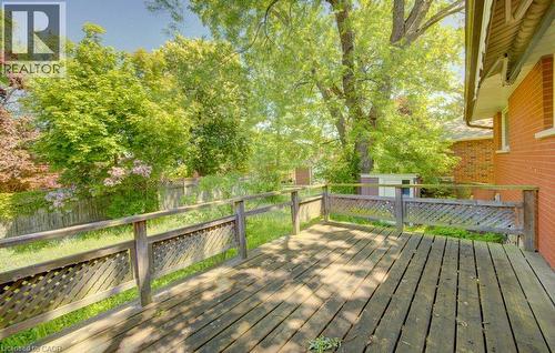 Wood deck with lattice railing and a red brick exterior - 80 Lower Canada Crescent, Kitchener, ON - Outdoor With Deck Patio Veranda