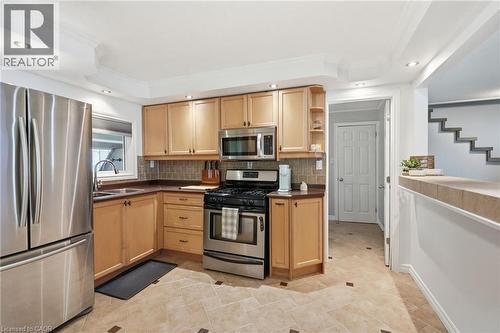 Kitchen featuring light wood cabinetry, stainless steel appliances, a tile backsplash, and recessed lighting - 432 Upper Sherman Avenue, Hamilton, ON - Indoor Photo Showing Kitchen With Double Sink