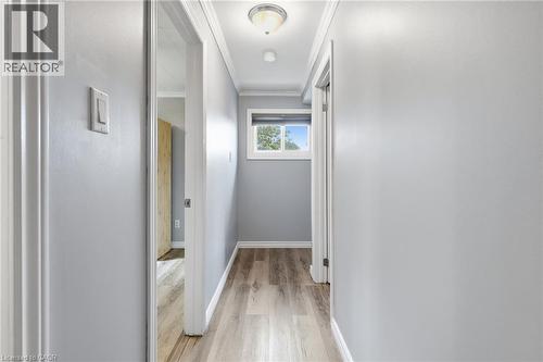 Hallway featuring wood-finish flooring, light grey wall paint, and white trim - 432 Upper Sherman Avenue, Hamilton, ON - Indoor Photo Showing Other Room