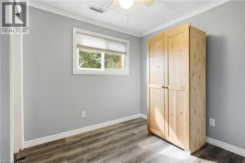 Room featuring light gray walls, wood-finish flooring, and a white ceiling with a flush-mount light and ceiling fan - 432 Upper Sherman Avenue, Hamilton, ON - Indoor Photo Showing Other Room