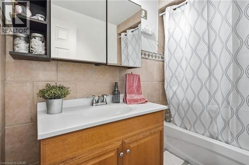 Bathroom vanity with a wood-finish cabinet, integrated sink, and chrome faucet - 432 Upper Sherman Avenue, Hamilton, ON - Indoor Photo Showing Bathroom