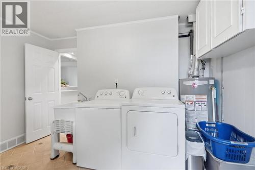 Dedicated laundry area featuring a utility sink, upper cabinetry, and tiled flooring - 432 Upper Sherman Avenue, Hamilton, ON - Indoor Photo Showing Laundry Room