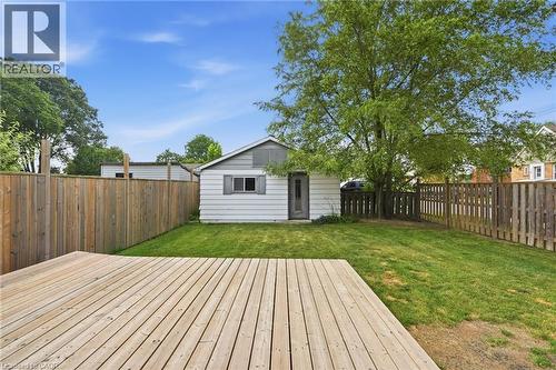 Spacious backyard featuring a wood deck, manicured lawn, and privacy fencing - 432 Upper Sherman Avenue, Hamilton, ON - Outdoor
