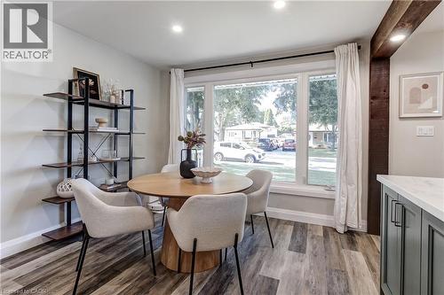 Dining area featuring a large window, wood-finish flooring, a built-in wood beam, and recessed lighting - 323 Cranbrook Drive, Hamilton, ON - Indoor Photo Showing Dining Room