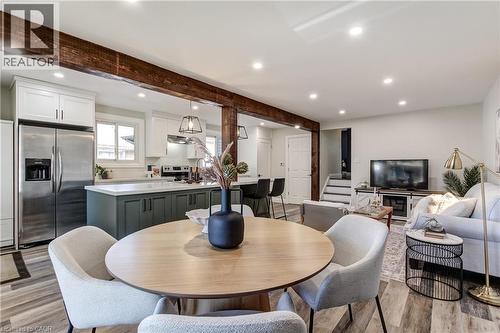 Open-concept living space featuring wood-finish flooring, recessed lighting, and exposed wood beams - 323 Cranbrook Drive, Hamilton, ON - Indoor Photo Showing Dining Room