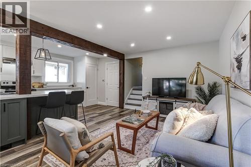 Open-concept living area featuring exposed wood beams and wood-finish flooring - 323 Cranbrook Drive, Hamilton, ON - Indoor Photo Showing Other Room