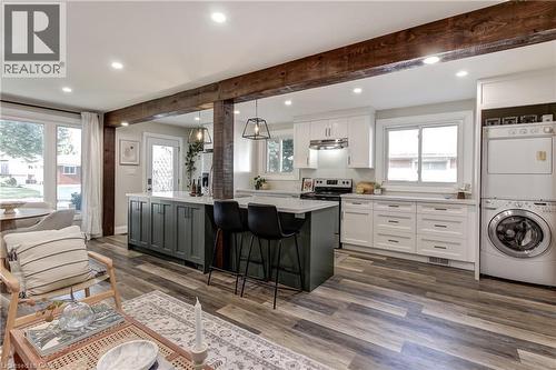 Open-concept living space featuring wood-finish flooring, exposed wood beams, and recessed lighting - 323 Cranbrook Drive, Hamilton, ON - Indoor Photo Showing Kitchen