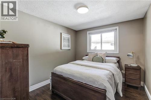 Room featuring wood-finish flooring, neutral wall paint, and white baseboards - 323 Cranbrook Drive, Hamilton, ON - Indoor Photo Showing Bedroom