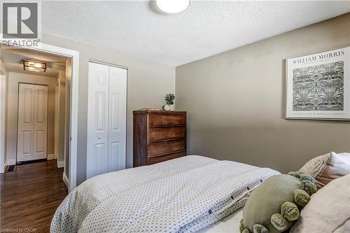 Neutral-toned walls complement wood-finish flooring - 323 Cranbrook Drive, Hamilton, ON - Indoor Photo Showing Bedroom