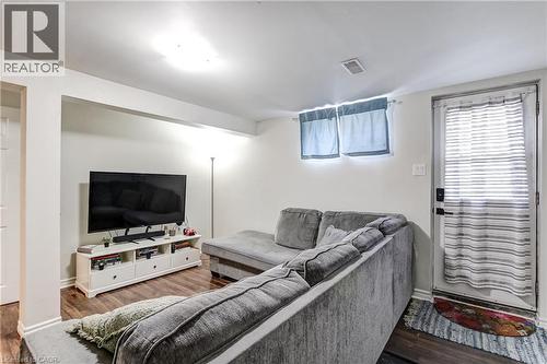 Living area featuring wood-finish flooring, recessed ceiling lighting, and a white media console - 323 Cranbrook Drive, Hamilton, ON - Indoor Photo Showing Living Room