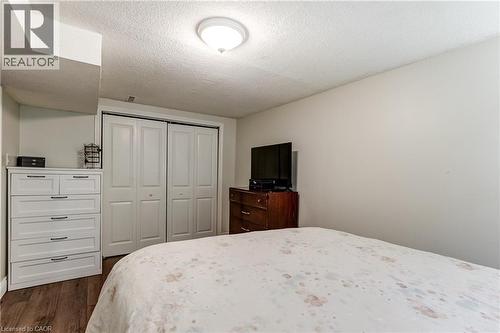 Room featuring wood-finish flooring, light-toned walls, and a white bi-fold closet - 323 Cranbrook Drive, Hamilton, ON - Indoor Photo Showing Bedroom