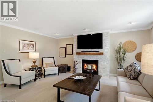 Stone-clad fireplace with a wood mantel - 1090 Crofton Way, Burlington, ON - Indoor Photo Showing Living Room With Fireplace