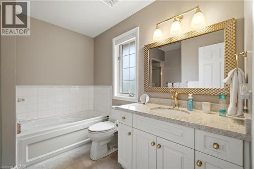 Bathroom vanity with a white cabinetry, light-toned countertop, and undermount sink - 1090 Crofton Way, Burlington, ON - Indoor Photo Showing Bathroom