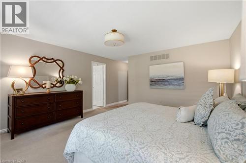 Plush carpeting and neutral wall tones define this expansive interior - 1090 Crofton Way, Burlington, ON - Indoor Photo Showing Bedroom