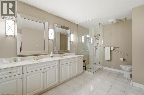 Double vanity with white cabinetry, gold-tone hardware, and rectangular framed mirrors - 1090 Crofton Way, Burlington, ON - Indoor Photo Showing Bathroom