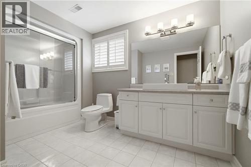 Bathroom featuring a white vanity with multiple cabinets, a rectangular vessel sink, and a large wall-mounted mirror - 1090 Crofton Way, Burlington, ON - Indoor Photo Showing Bathroom
