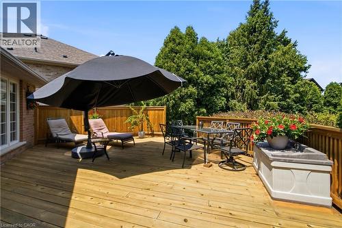 Spacious wood-finish deck with wooden railings, featuring a dining area and privacy fencing - 1090 Crofton Way, Burlington, ON - Outdoor With Deck Patio Veranda