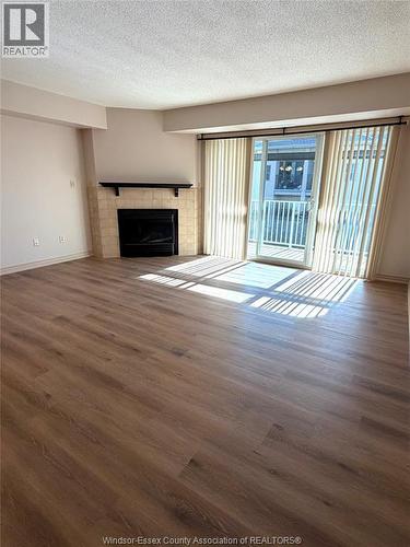 1995 Normandy Unit# 301, Lasalle, ON - Indoor Photo Showing Living Room With Fireplace