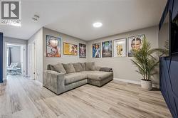 Spacious interior room featuring wood-finish flooring, recessed lighting, and a modern accent wall - 