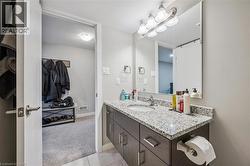 Bathroom featuring a vanity with granite countertop and integrated sink - 