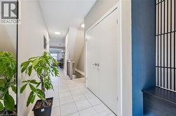 Entryway featuring light-toned tile flooring and white walls - 