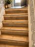 Staircase featuring wood-finish treads with integrated strip lighting, white risers, and a white baluster railing - 143 Grenfell Place, London, ON  - Indoor Photo Showing Other Room 