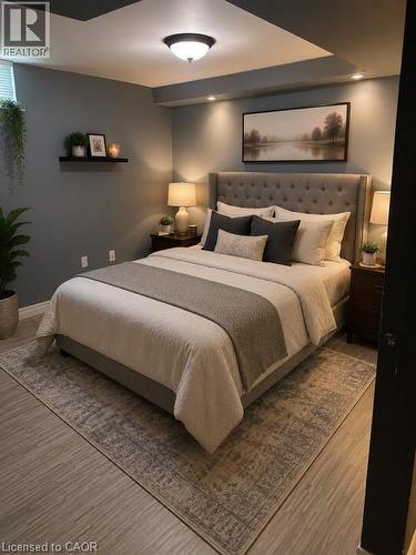 Tufted fabric headboard with integrated recessed lighting, wood-finish flooring, and a flush-mount ceiling light - 143 Grenfell Place, London, ON - Indoor Photo Showing Bedroom