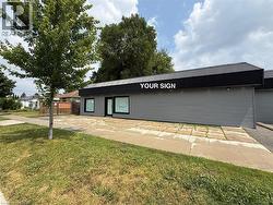 Commercial building with a flat, horizontal profile and a black corrugated metal roofline - 