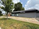 Commercial building with a flat, horizontal profile and a black corrugated metal roofline - 116 St Clair Avenue, Kitchener, ON 