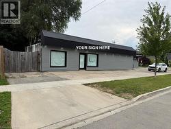 Commercial building with gray horizontal siding and a dark roofline - 