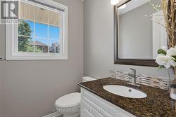 Handy main level powder room is well appointed - 
