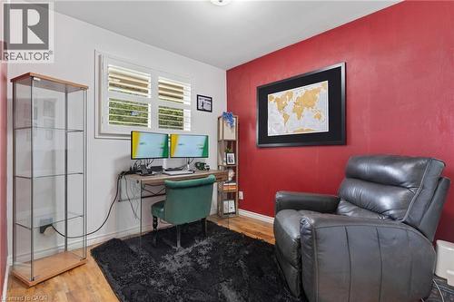 Room featuring wood-finish flooring and a window with white louvered shutters - 744 Birchwood Avenue, Cambridge, ON - Indoor