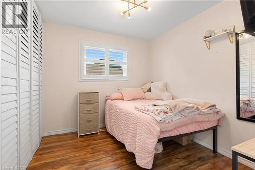 Wood-finish flooring complemented by light-toned walls - 744 Birchwood Avenue, Cambridge, ON - Indoor Photo Showing Bedroom