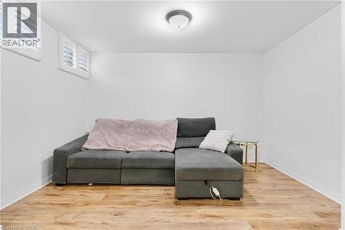 Room featuring wood-finish flooring, white baseboards, and bright white walls - 744 Birchwood Avenue, Cambridge, ON - Indoor Photo Showing Living Room