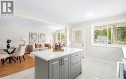 Kitchen island featuring a white countertop and gray cabinetry, set against white tile flooring - 