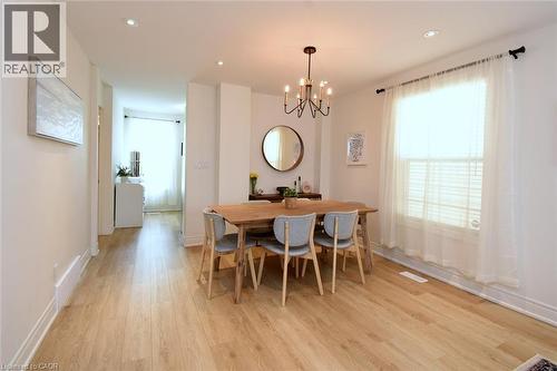 Open dining area featuring wood-finish flooring, a contemporary chandelier, and recessed lighting - 106 Belview Avenue, Hamilton, ON - Indoor Photo Showing Dining Room