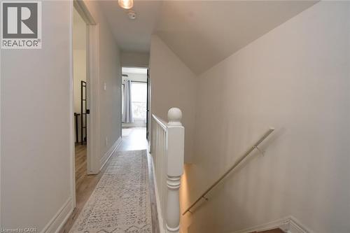 Hallway with light-toned walls and wood-finish flooring - 106 Belview Avenue, Hamilton, ON - Indoor Photo Showing Other Room