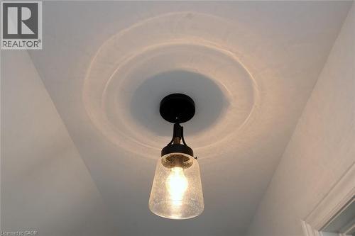 Black finish semi-flush mount light fixture with a seeded glass shade - 106 Belview Avenue, Hamilton, ON - Indoor Photo Showing Other Room