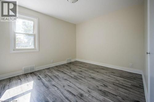 Interior room featuring light neutral wall paint, wood-finish flooring, and white trim - 33 Sixth Avenue Unit# Upper, Kitchener, ON - Indoor Photo Showing Other Room