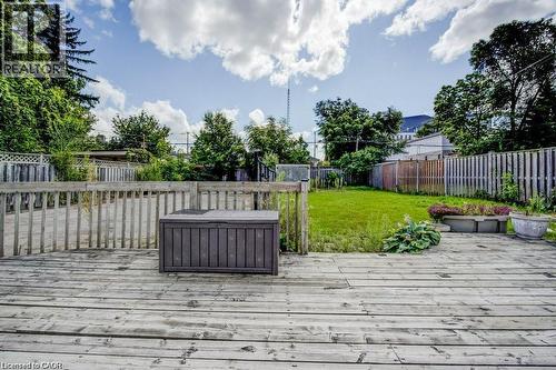 Wood deck with a slatted railing overlooking a grassy yard - 33 Sixth Avenue Unit# Upper, Kitchener, ON - Outdoor With Deck Patio Veranda