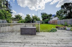 Wood deck with a slatted railing overlooking a grassy yard - 