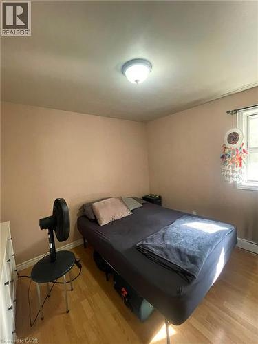 Room featuring wood-finish flooring, a flush-mount ceiling light fixture, and a window with trim - 267 Mackie Place Unit# 2, Kitchener, ON - Indoor Photo Showing Bedroom