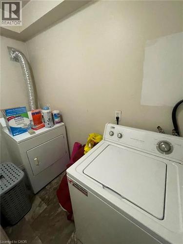 Dedicated laundry area featuring a white top-load washer, a white dryer unit, and neutral wall tones - 267 Mackie Place Unit# 2, Kitchener, ON - Indoor Photo Showing Laundry Room